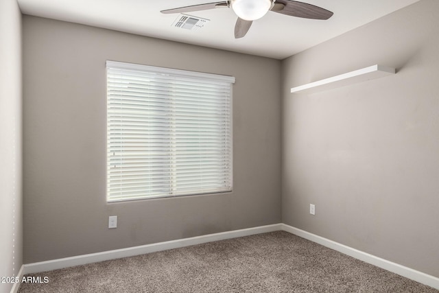 spare room featuring a ceiling fan, carpet, visible vents, and baseboards