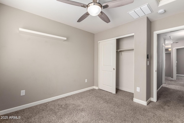 unfurnished bedroom featuring carpet, a closet, visible vents, and baseboards