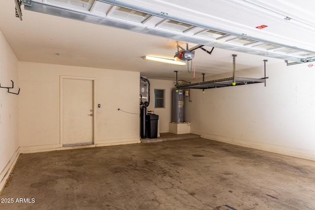 garage with baseboards, electric water heater, and a garage door opener