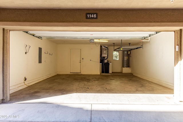 garage featuring water heater, electric panel, and a garage door opener