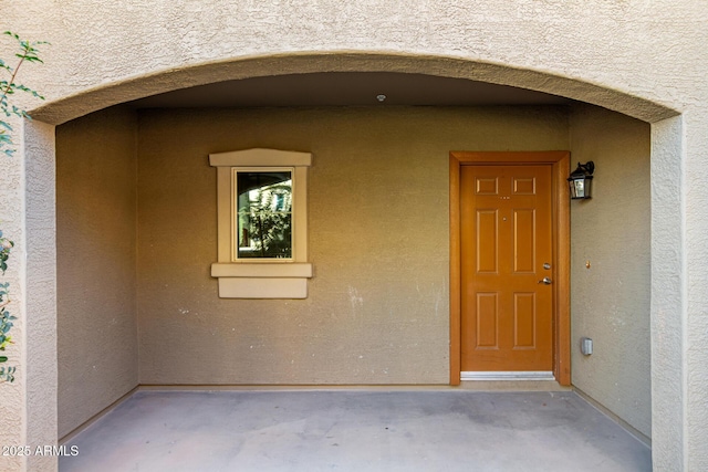 doorway to property with stucco siding