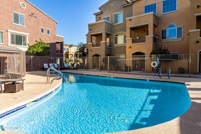 pool featuring a patio area and fence