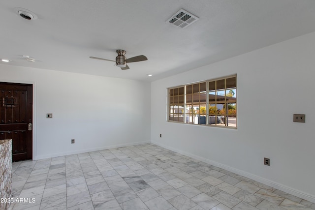 unfurnished room with visible vents, marble finish floor, baseboards, and ceiling fan