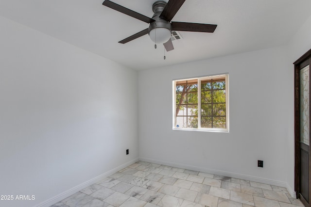 spare room with visible vents, ceiling fan, and baseboards