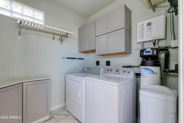 laundry area featuring baseboards, cabinet space, marble finish floor, and washing machine and dryer