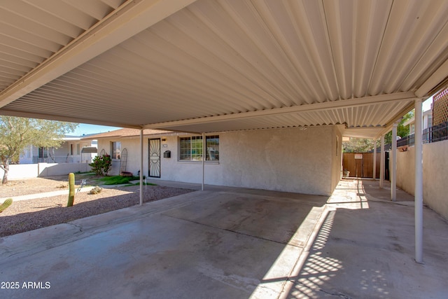 view of patio / terrace featuring a carport and fence