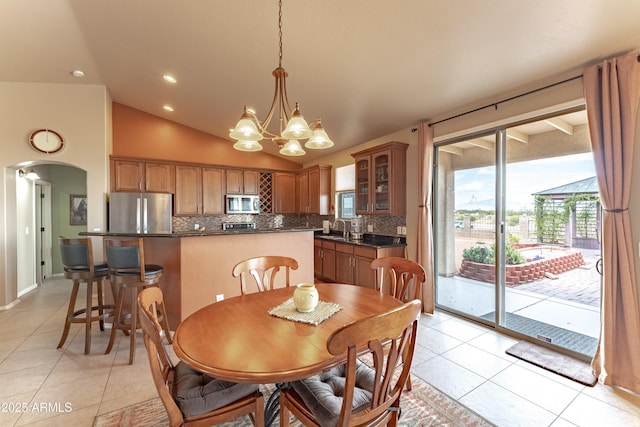 1398 W Sheep Wash Way, Benson, AZ 85602 - dining area with light tile patterned floors, lofted ceiling, arched walkways, a chandelier, and recessed lighting