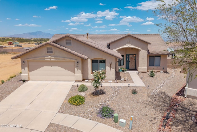 1398 W Sheep Wash Way, Benson, AZ 85602 - mediterranean / spanish-style home featuring stucco siding, an attached garage, concrete driveway, a tile roof, and a mountain view