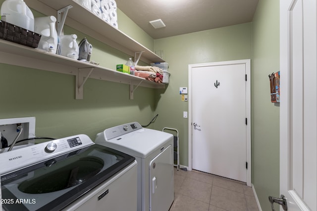 1398 W Sheep Wash Way, Benson, AZ 85602 - laundry room featuring washer and dryer, light tile patterned floors, and baseboards
