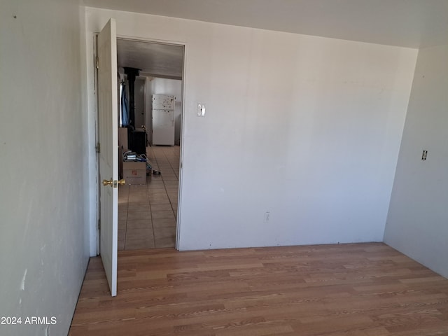 empty room with light hardwood / wood-style flooring