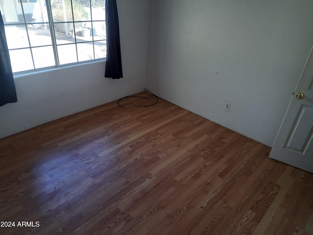 empty room with hardwood / wood-style flooring