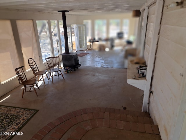 unfurnished sunroom with a wood stove