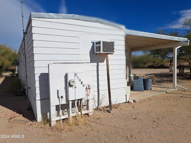 view of outbuilding with an AC wall unit