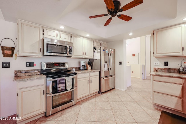 kitchen featuring light tile patterned floors, appliances with stainless steel finishes, light stone counters, and ceiling fan