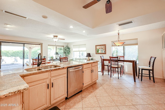 kitchen with dishwasher, light brown cabinets, sink, hanging light fixtures, and light tile patterned flooring