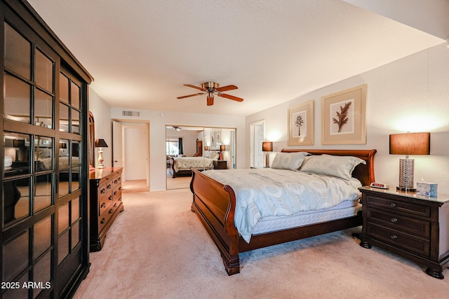 bedroom with ceiling fan and light colored carpet