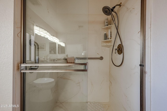 bathroom with a shower with shower door