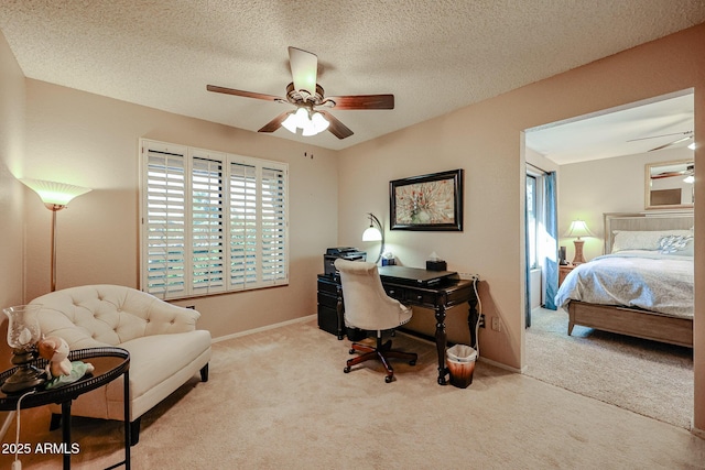 carpeted office with a textured ceiling, ceiling fan, and plenty of natural light