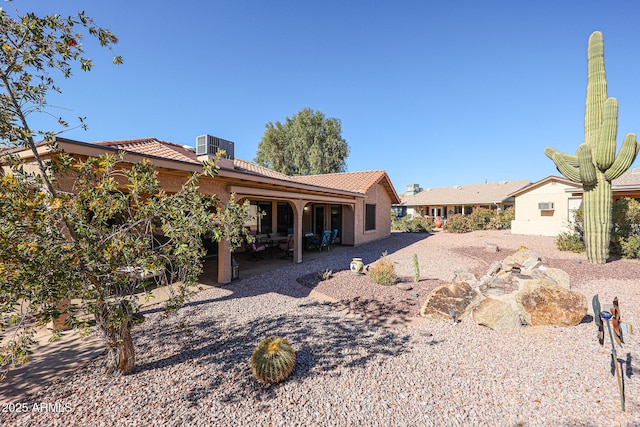 rear view of house with cooling unit and a patio