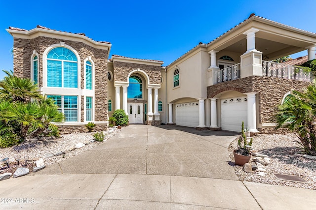 mediterranean / spanish-style home with a garage and a balcony