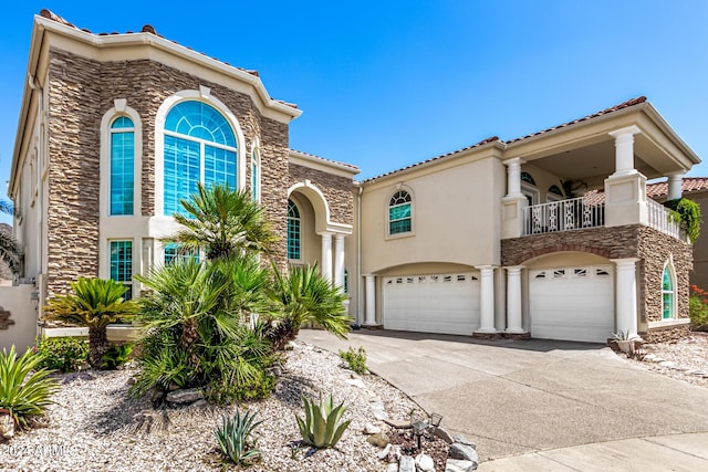 mediterranean / spanish home with a balcony and a garage