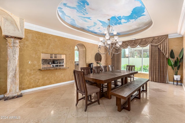 dining room with crown molding, a chandelier, and a tray ceiling