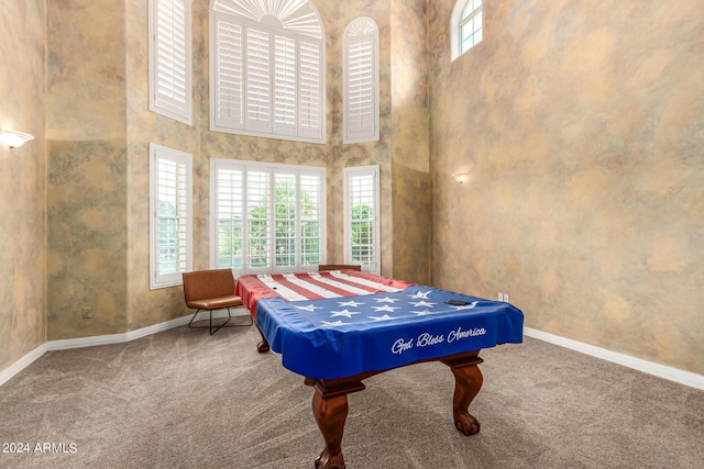 rec room featuring carpet floors, a towering ceiling, plenty of natural light, and billiards