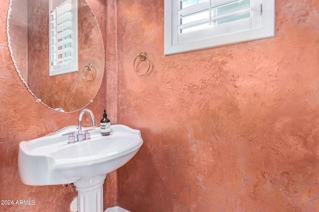 bathroom featuring plenty of natural light and sink