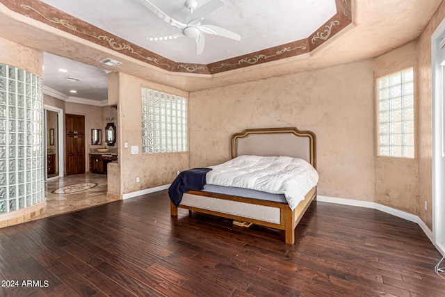 bedroom featuring crown molding, dark hardwood / wood-style floors, and ceiling fan