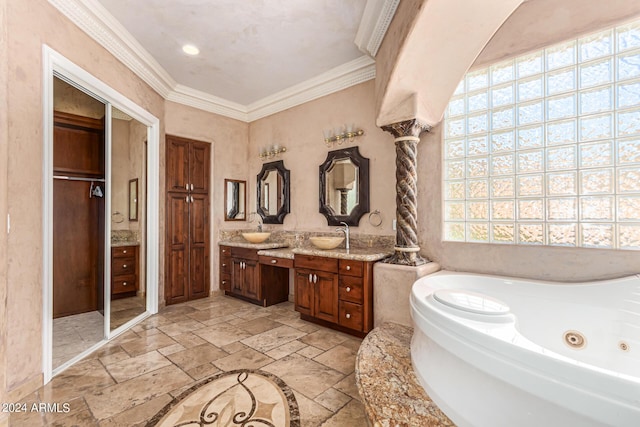 bathroom with crown molding, vanity, a bathtub, and decorative columns