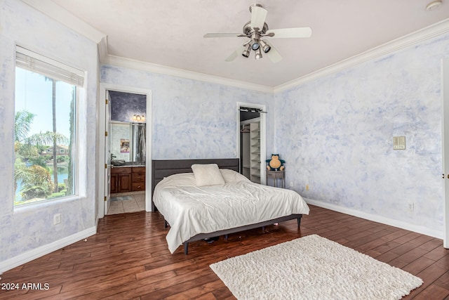 bedroom featuring ornamental molding, dark hardwood / wood-style floors, connected bathroom, and ceiling fan