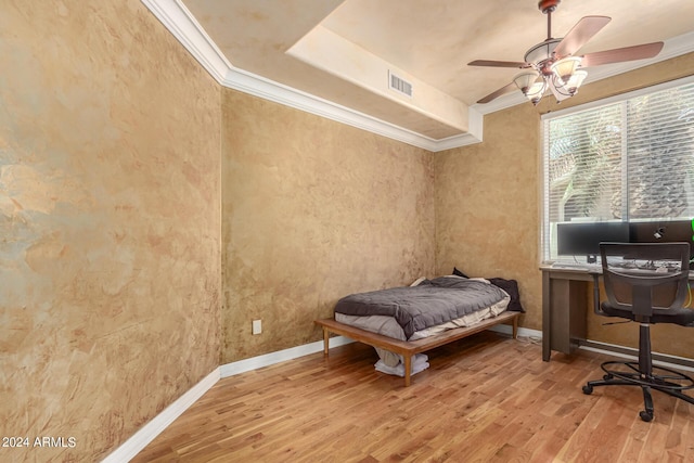 bedroom with ornamental molding, ceiling fan, and light hardwood / wood-style floors