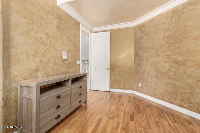 unfurnished bedroom featuring ornamental molding and light hardwood / wood-style flooring