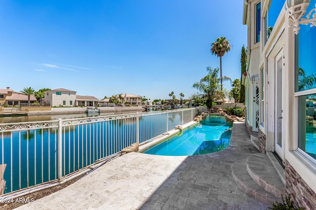 view of swimming pool with a water view