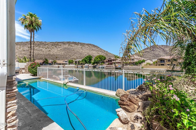 view of pool with a water and mountain view