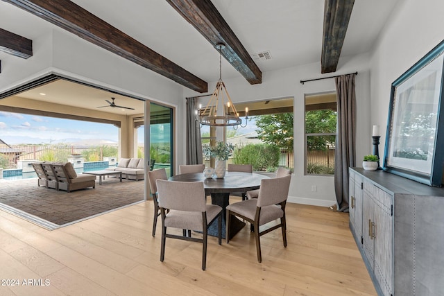 dining room featuring light hardwood / wood-style flooring, beam ceiling, and ceiling fan with notable chandelier