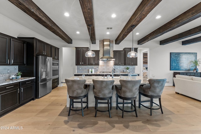 kitchen with beamed ceiling, stainless steel fridge with ice dispenser, wall chimney range hood, and light wood-type flooring