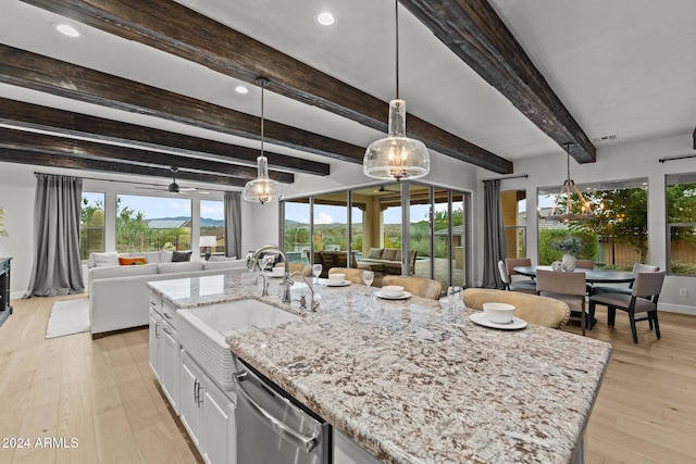 kitchen featuring light hardwood / wood-style flooring, white cabinets, beamed ceiling, and sink