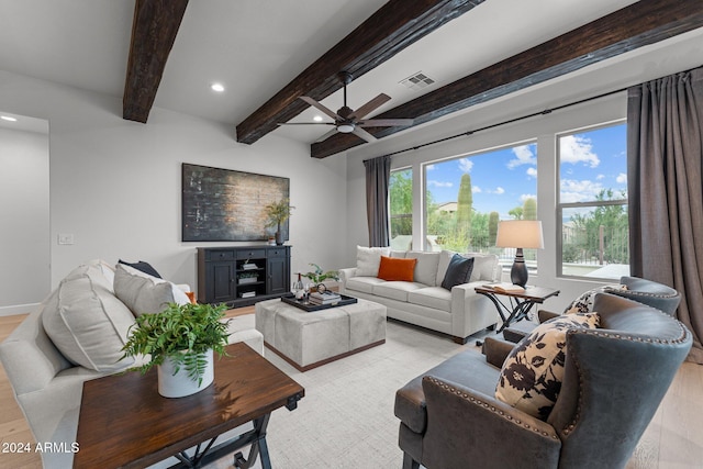 living room with light hardwood / wood-style flooring, beam ceiling, and ceiling fan