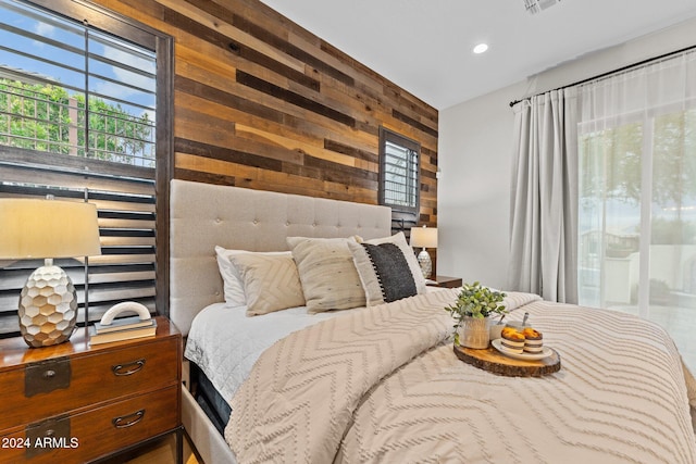 bedroom featuring wood walls