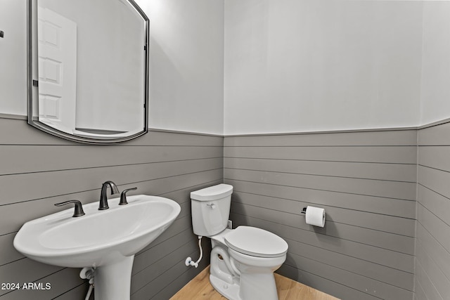 bathroom featuring toilet, hardwood / wood-style floors, and sink