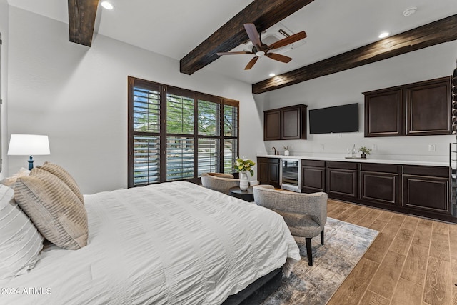 bedroom featuring beamed ceiling, ceiling fan, light hardwood / wood-style floors, and beverage cooler