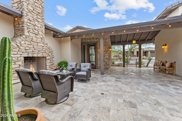 view of patio featuring an outdoor living space with a fireplace