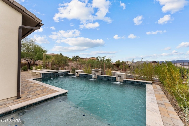 view of swimming pool featuring pool water feature and an in ground hot tub