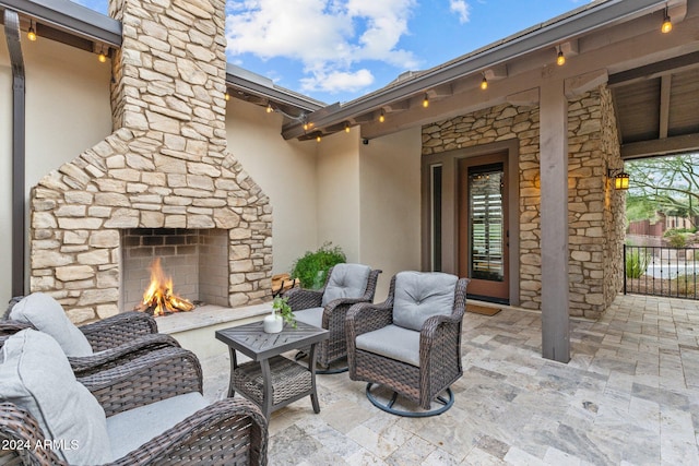 view of patio with an outdoor stone fireplace