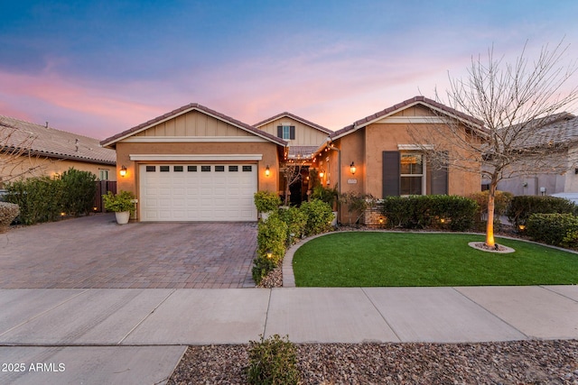 view of front of property featuring a garage and a lawn