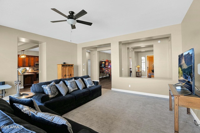 carpeted living room with ceiling fan