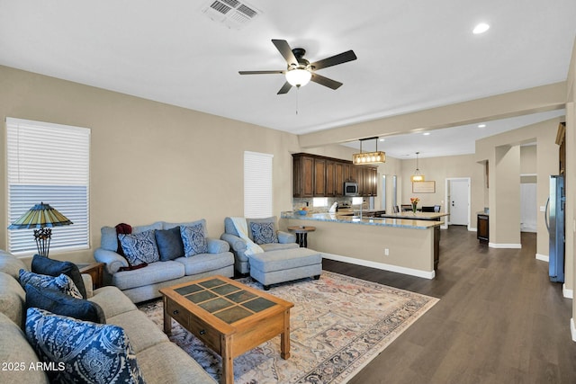 living room with ceiling fan, sink, and dark hardwood / wood-style flooring