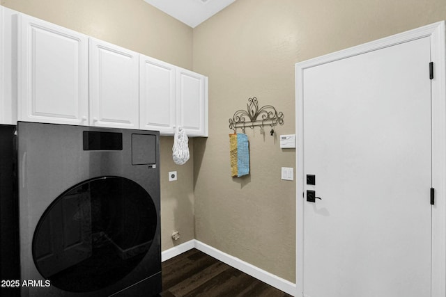 clothes washing area featuring washer / clothes dryer, dark hardwood / wood-style floors, and cabinets