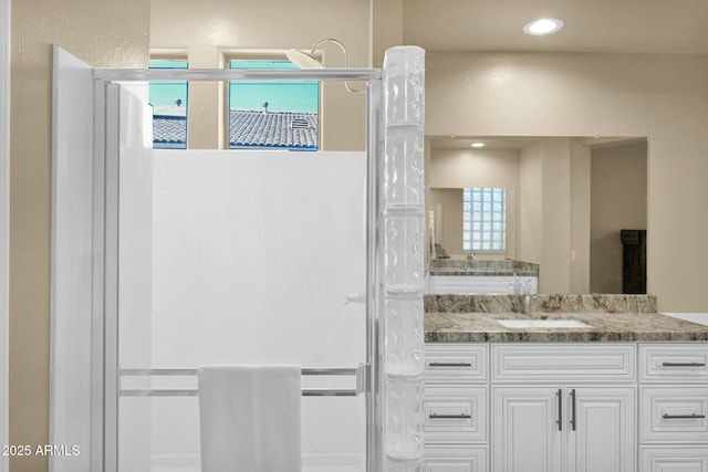 bathroom with vanity and walk in shower